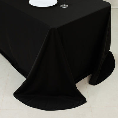 Black tablecloth draped elegantly on a table in a minimalist setting.