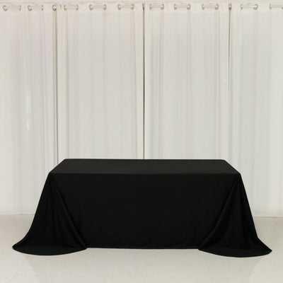 Black tablecloth draped over a table in a minimalistic setting.