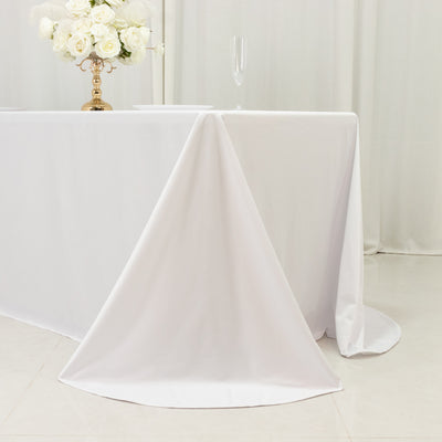 Elegant white tablecloth draping over a table at a stylish event.