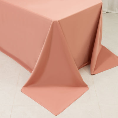 Peach satin tablecloth close-up on table edge