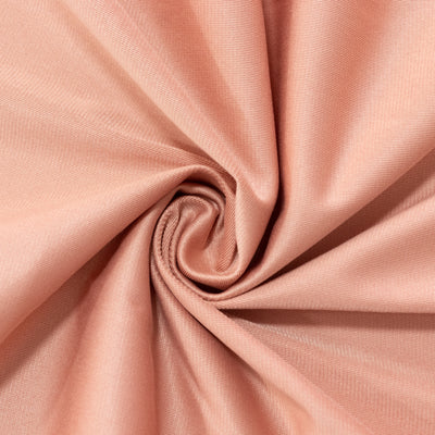 Soft peach fabric with a smooth texture in a spiral pattern. #whtbkgd