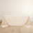 Beige tablecloth draped over a table with elegant folds.