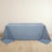 Blue tablecloth draped over a table on a light wooden floor.