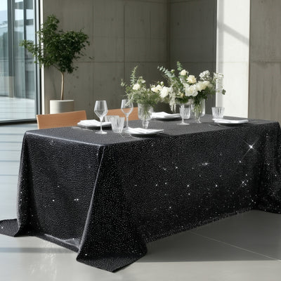 Elegant black tablecloth adorned with sparkling details, set for a stylish dining experience.