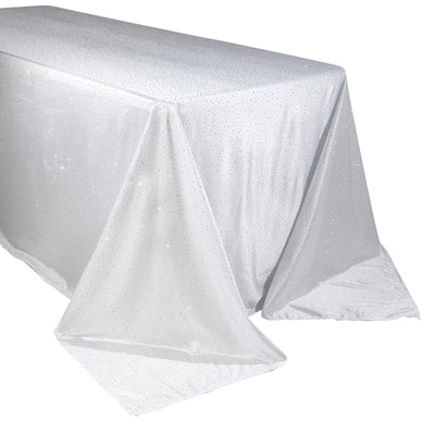 Sparkling white tablecloth with shimmering details, draped elegantly.