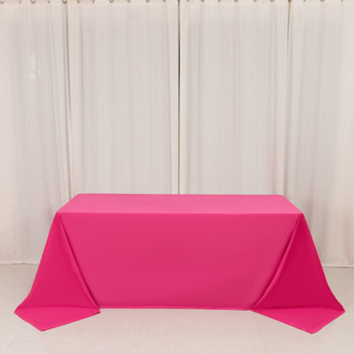 Hot pink tablecloth on rectangular table in a room