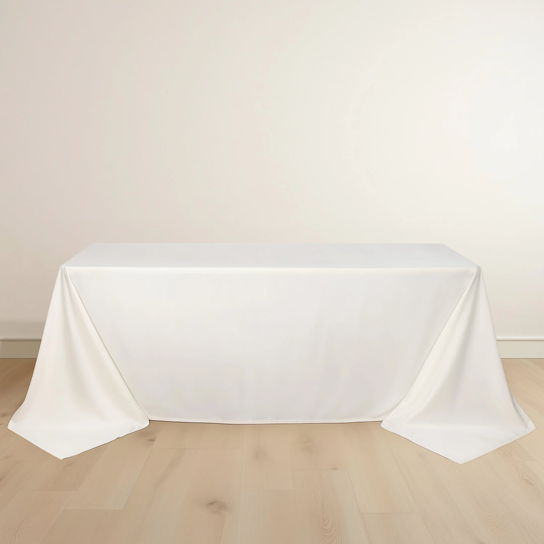 White tablecloth draped elegantly over a table in a minimalist setting.
