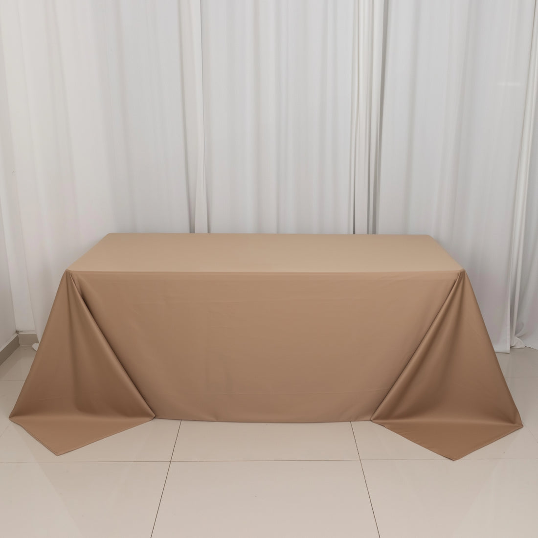Brown tablecloth draped over a table in a studio setting.