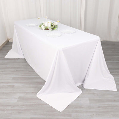 White tablecloth draped elegantly over a table for events or dining.