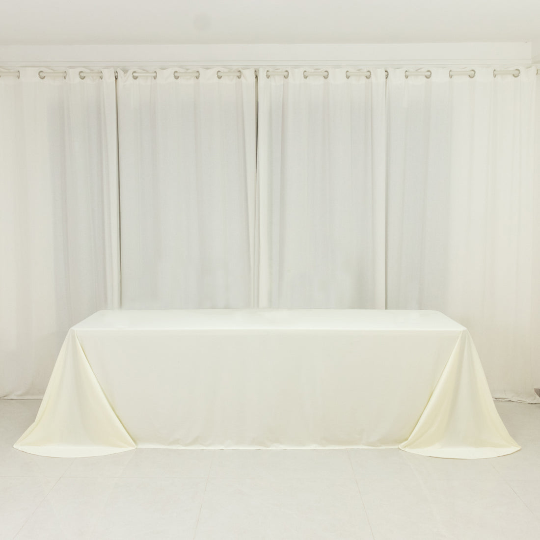 White table with a smooth tablecloth draped elegantly over it.