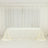 White table with a smooth tablecloth draped elegantly over it.