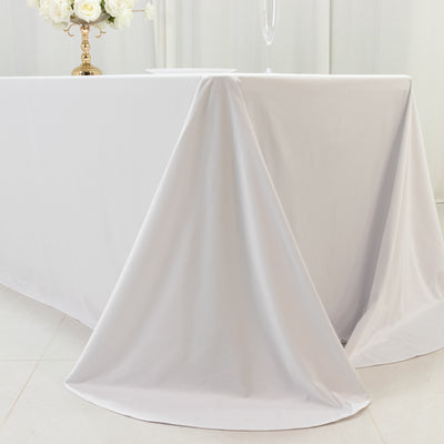 Elegant white tablecloth draped over a table in a bright setting.