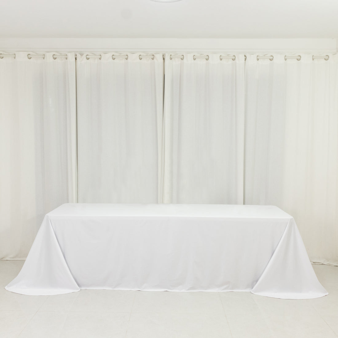 White tablecloth draped over a table in a bright, airy room.