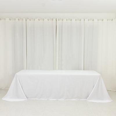 White tablecloth draped over a table in a bright, airy room.
