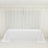 White tablecloth draped over a table in a bright, airy room.
