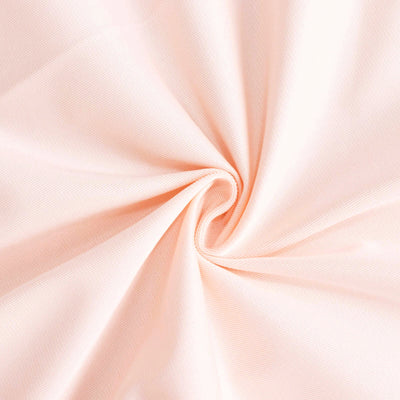 Peach-colored fabric with a smooth texture, showcasing a swirling pattern.