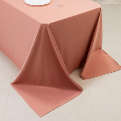 Peach tablecloth draped over table in a studio setting