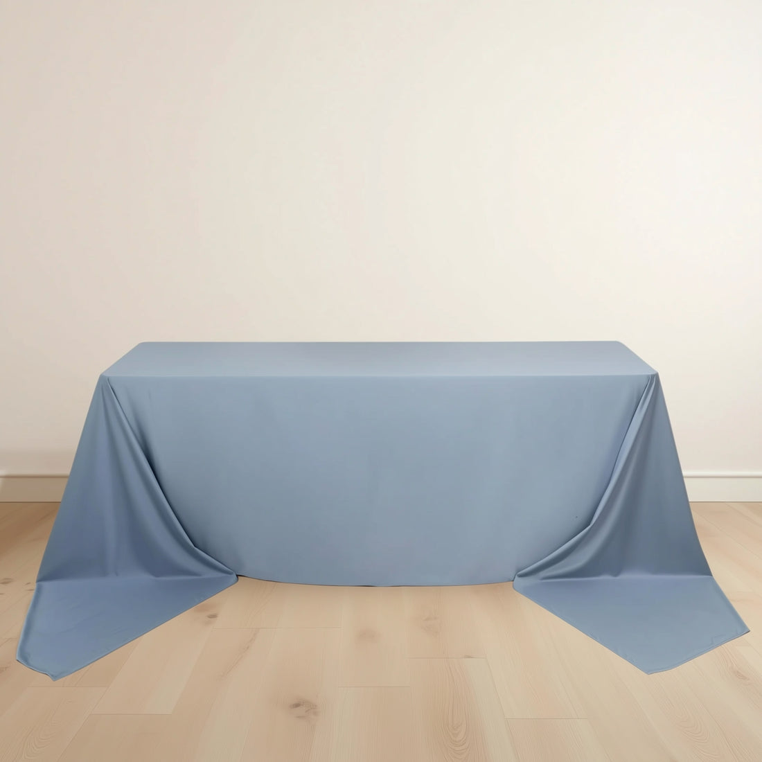Blue tablecloth draped elegantly over a table on a light wooden floor.