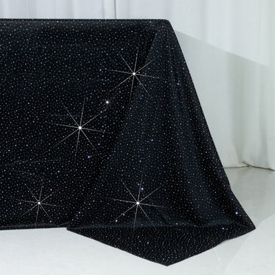 Black tablecloth with shimmering star-like embellishments