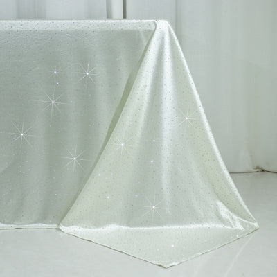 Sparkling silver tablecloth with star-like embellishments