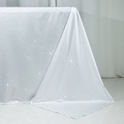 Sparkling silver tablecloth with star patterns draped elegantly.