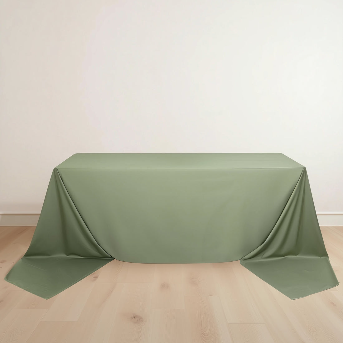 Green tablecloth draped over a table on a plain background.