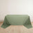 Green tablecloth draped over a table on a plain background.