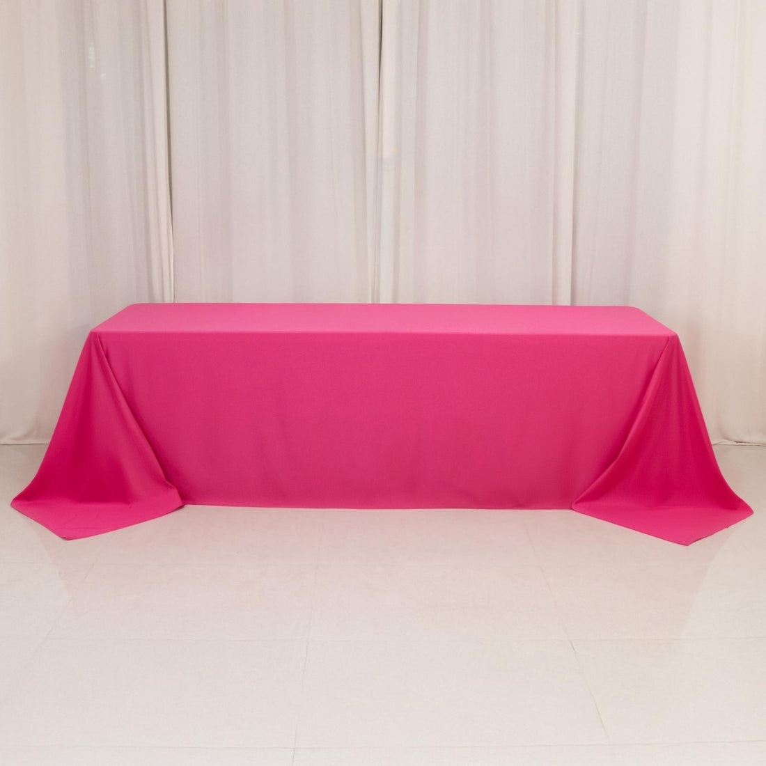 Hot pink tablecloth draped over banquet table