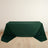 Green tablecloth draped over a table on a light wooden floor.