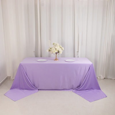 Lavender tablecloth draped over a table with decorative flowers and plates