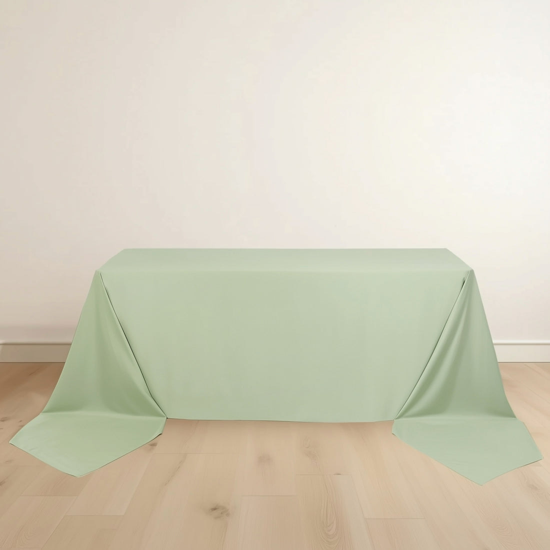 Mint green tablecloth with draped edges on a plain surface.