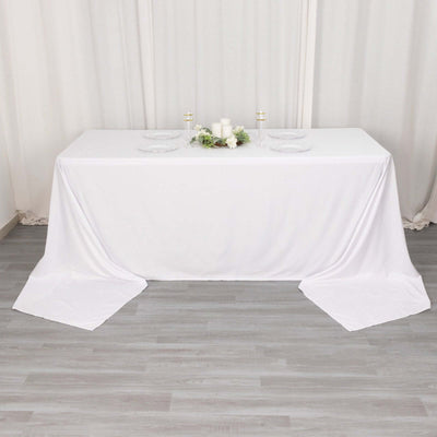 White tablecloth draped elegantly over a long table in a styled setting.