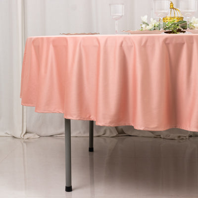 Pink tablecloth draped over a table with elegant decor elements.
