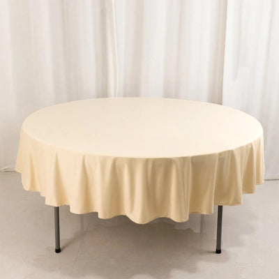 Round beige tablecloth draped over a table