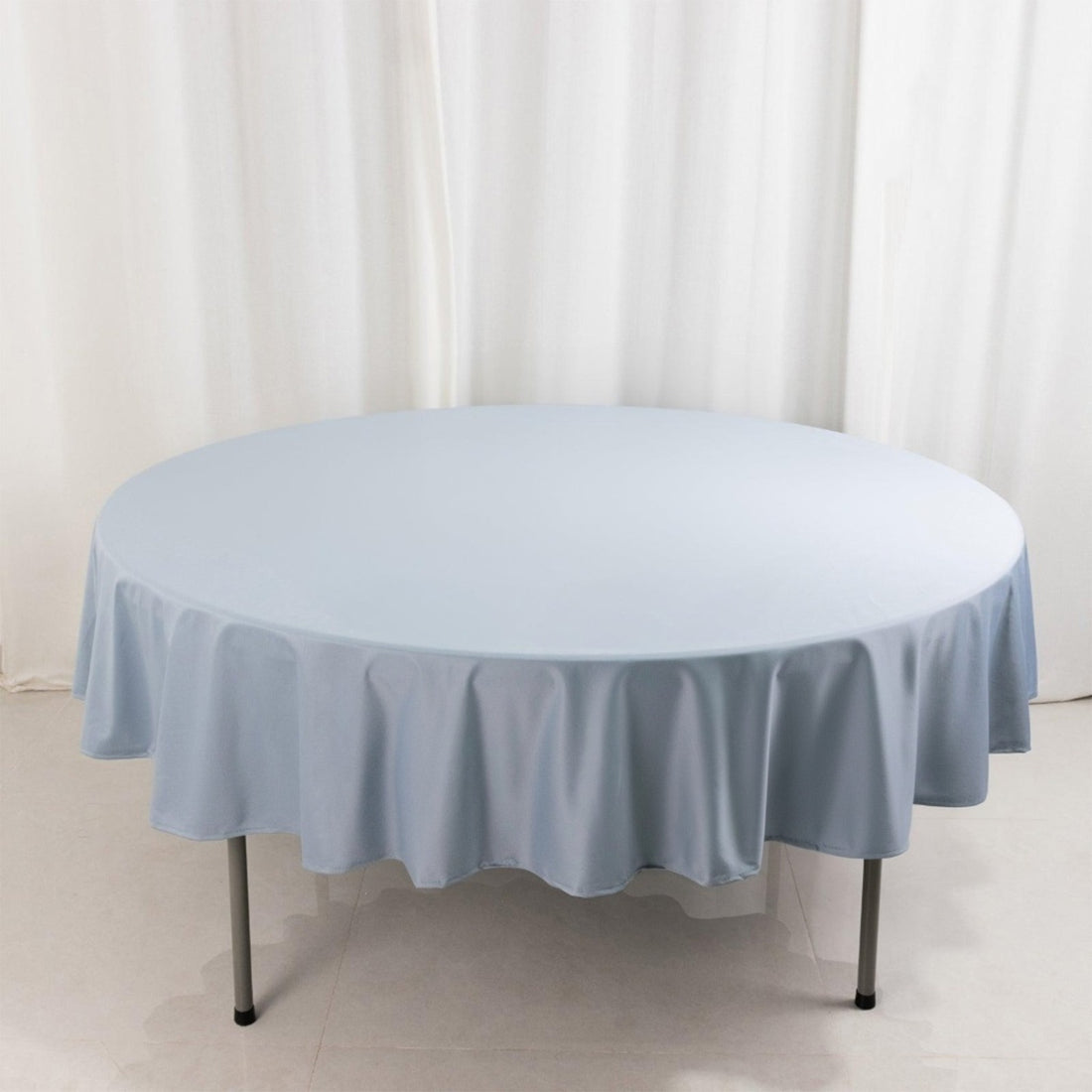 Round light blue tablecloth on a circular table.