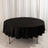Round black tablecloth draped over a table in studio setting