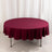 Round burgundy tablecloth draped elegantly over a table
