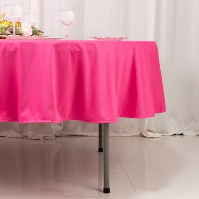 Pink tablecloth draping over a table with a soft sheen.