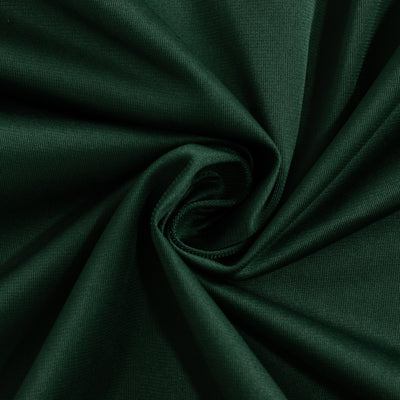 Dark green fabric texture in a swirling pattern.
