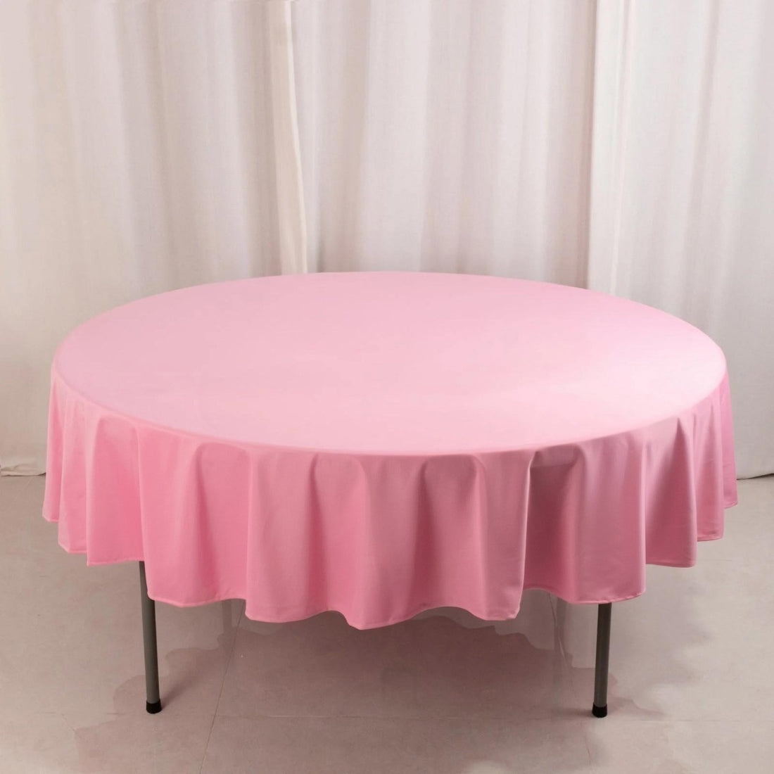 Pink round tablecloth draped over a table