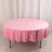 Pink round tablecloth draped over a table
