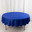 Round blue tablecloth on a table in a studio setting.
