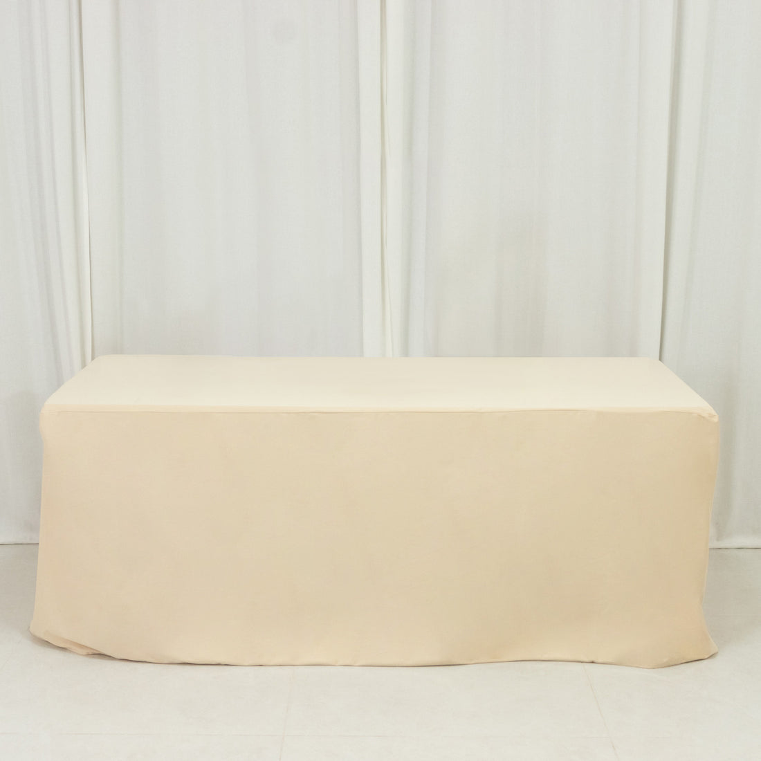 Beige table cover on a plain backdrop for events or home decor.