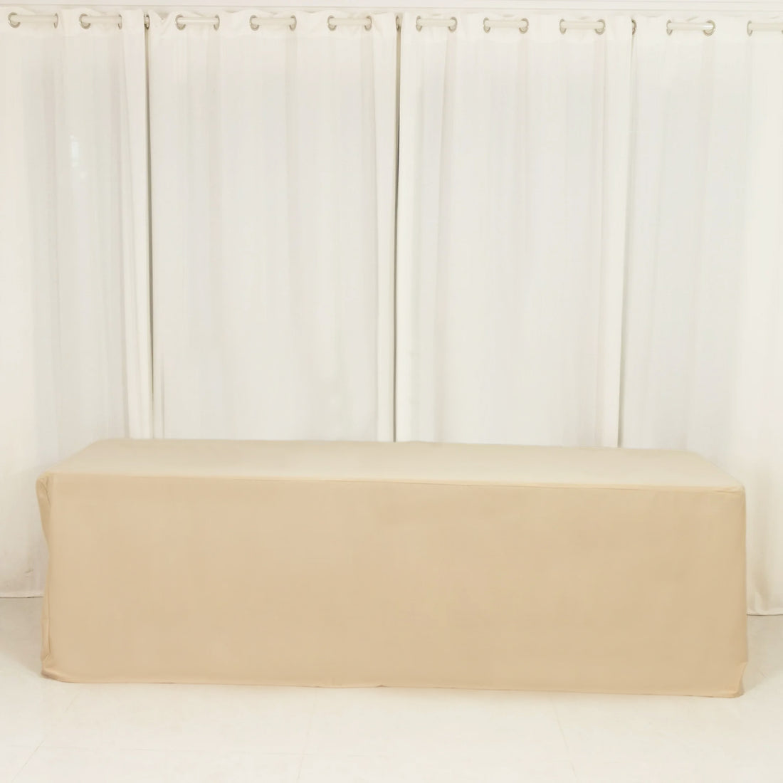Beige table cover on a plain backdrop