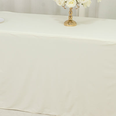 Elegant cream tablecloth draped over a table with floral centerpiece