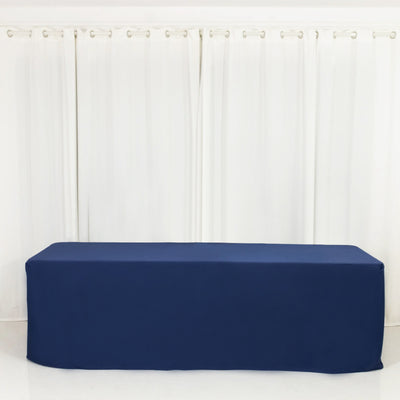 Navy blue tablecloth draped over a long table against a white backdrop