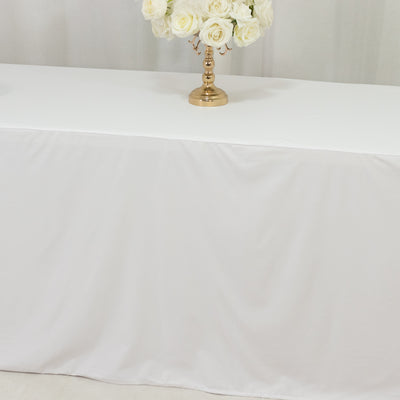 White tablecloth draped elegantly on a table with a gold flower vase.