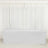 White table cover draped over a rectangular table in a bright room.