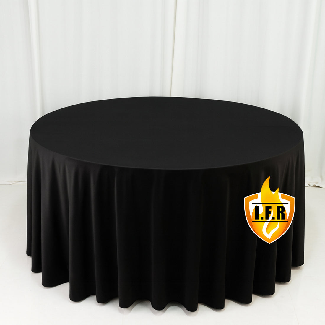 Black round tablecloth on white studio backdrop