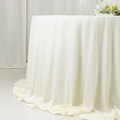 Elegant ivory tablecloth draping over a round table 